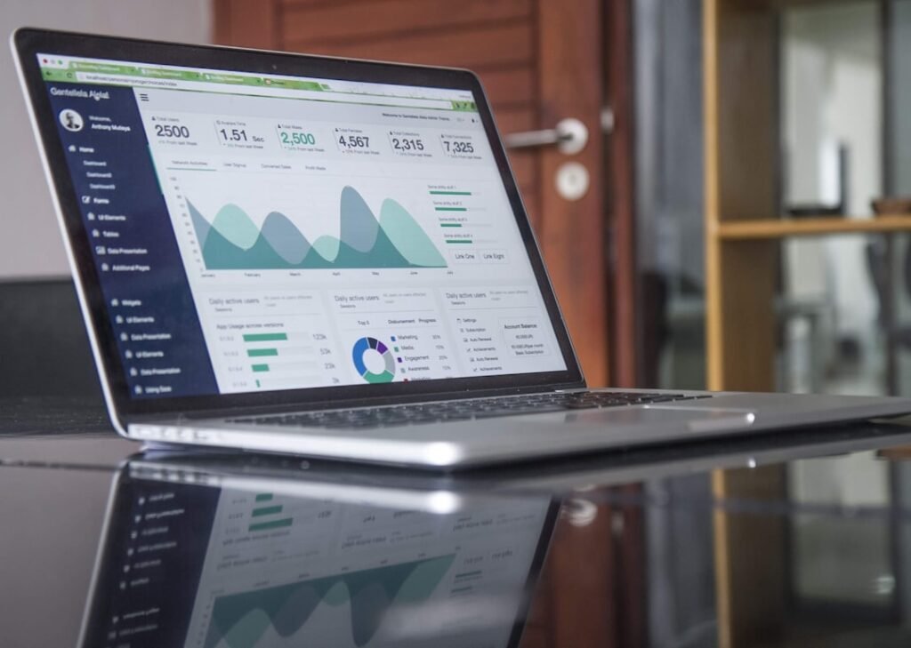 Business owner reviewing website analytics and maintenance performance on a laptop